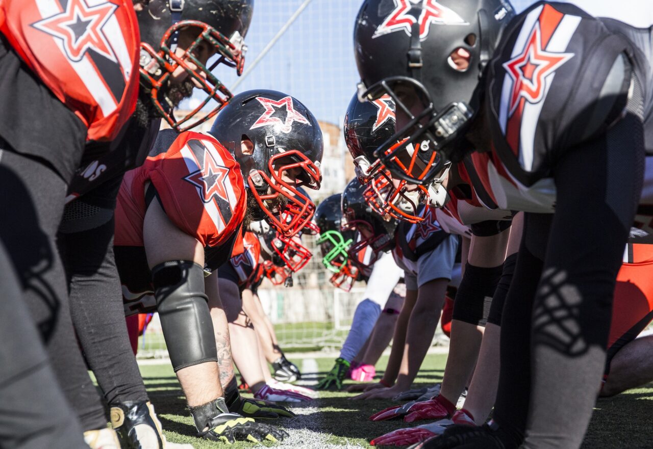 American football players on the line of scrimmage during a match